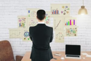 Businessman front brick wall with business scheme concept posters