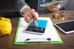 Finance manager using calculator