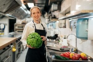 front view smiley female chef kitchen holding