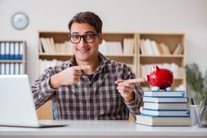 young student breaking piggy bank buy textbooks
