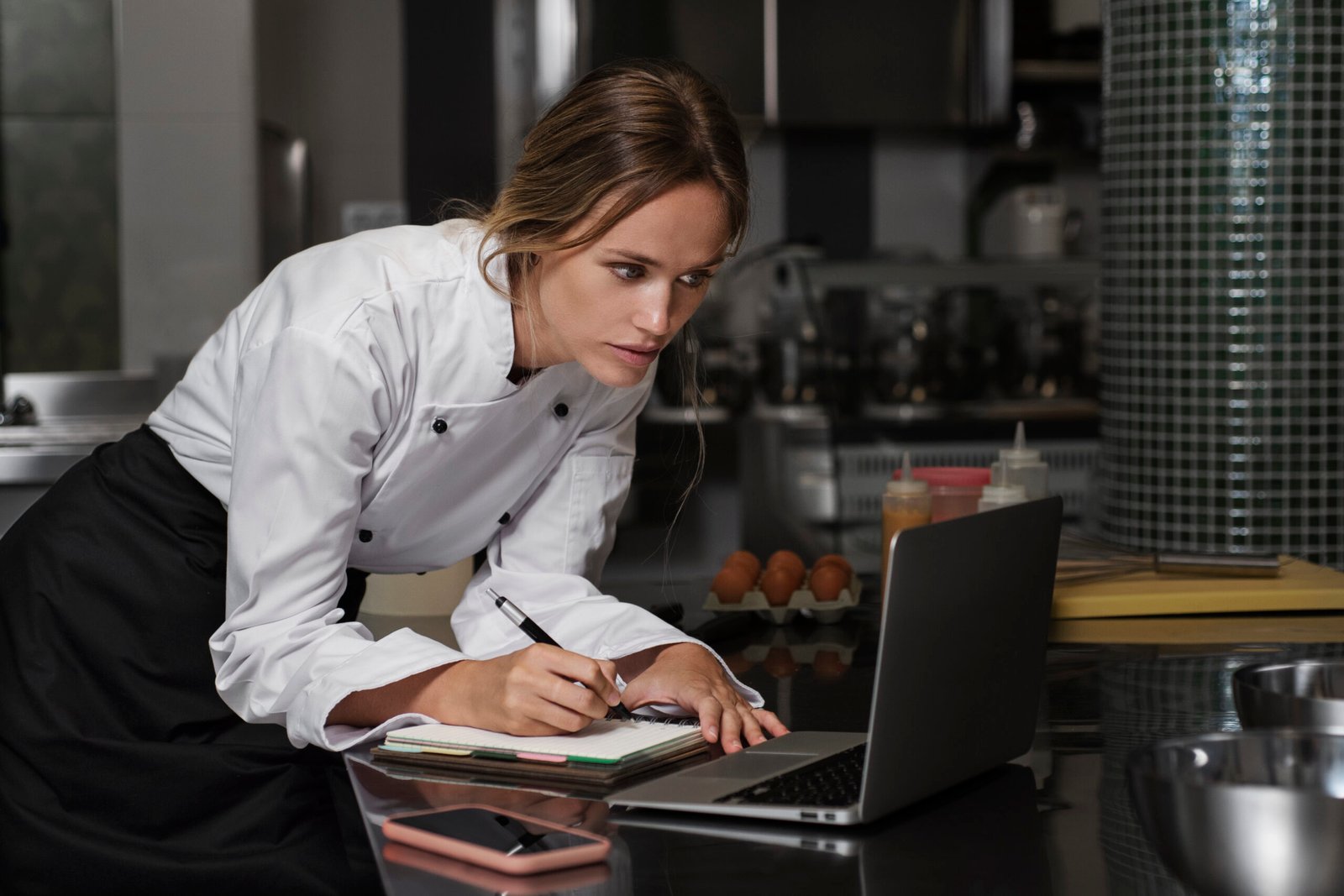 Female Chef Kitchen Using Laptop Device