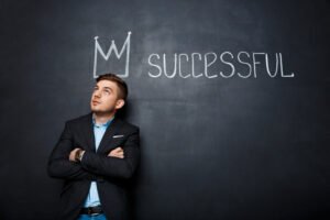 Picture man blackboard with crown text successful