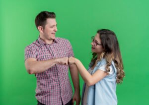 young cheerful couple man woman giving fist bump