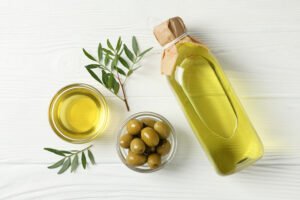 olives bottle bowl with olive oil wooden