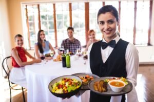 waitress holding food plate restaurant