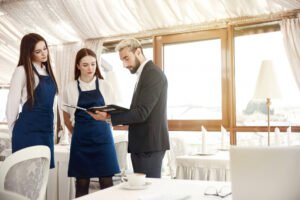 Director restaurant is giving work instructions waitresses