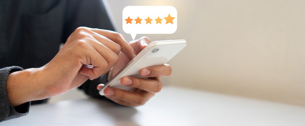 man-hand-press-smartphone screen with gold five-star rating feedback