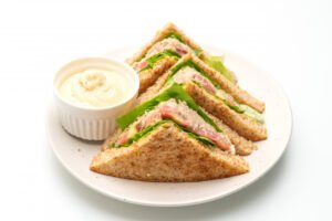 Homemade tuna sandwich on a white background