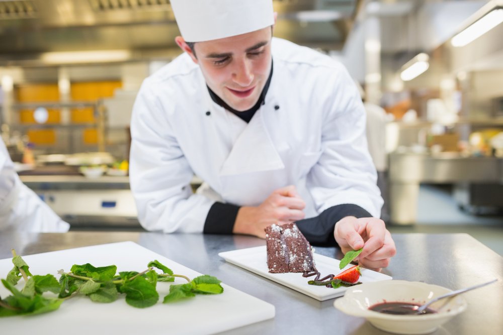 handsome chef plating dishes