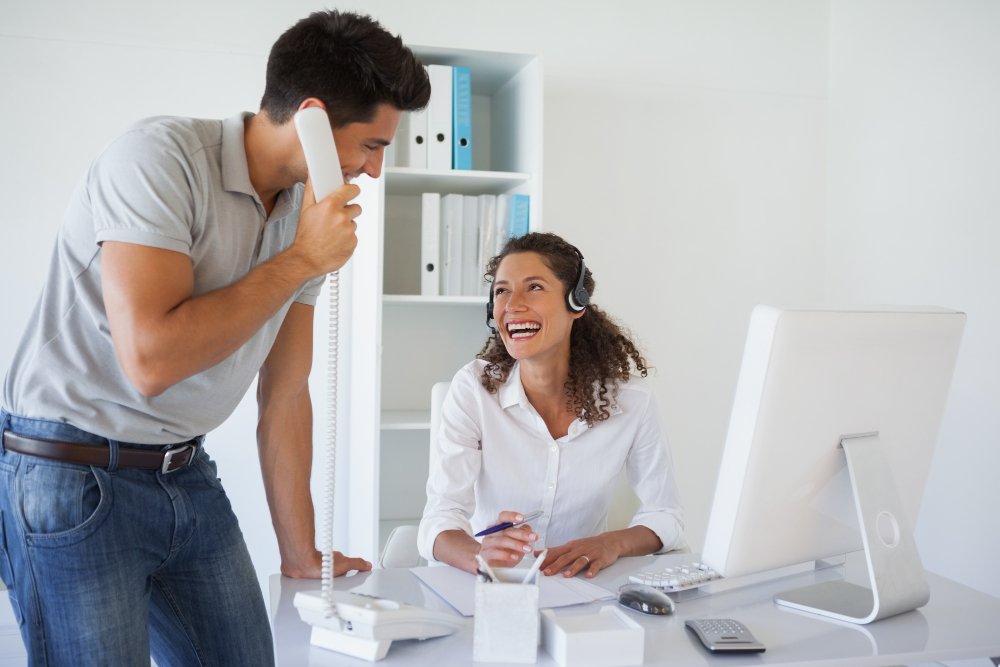 casual business team laughing together desk