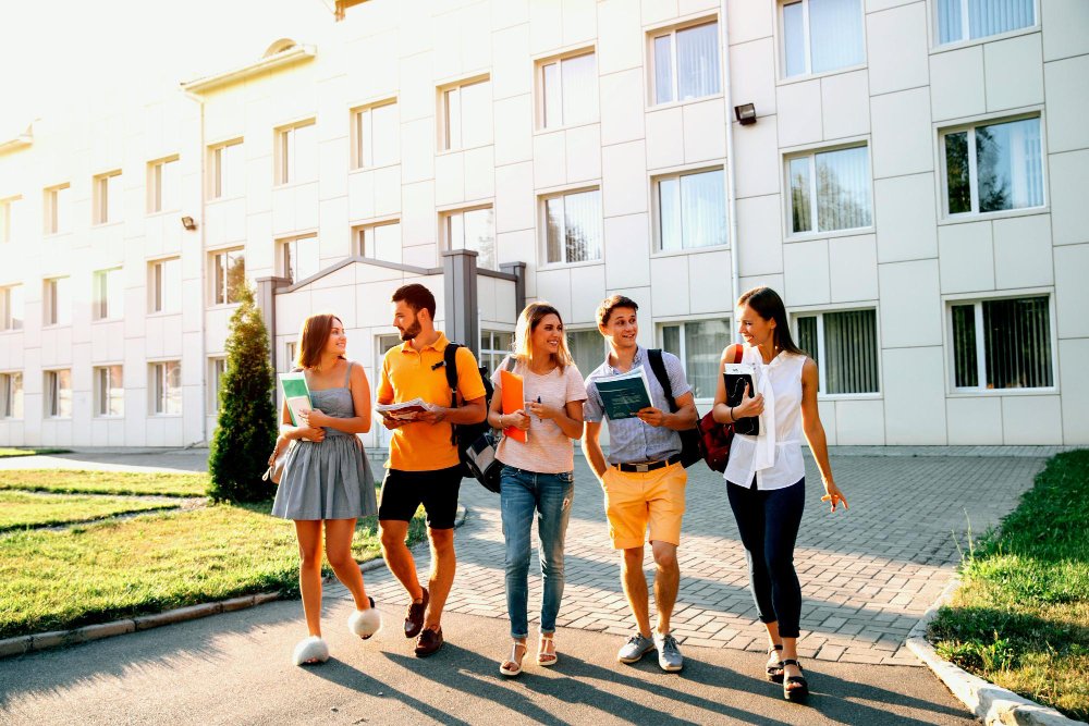 group people walking front of the building with book back