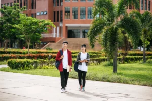  students wear a face chill and stand in front of the university