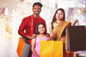 Beautiful indian family holding shopping bags with gifts in a mall