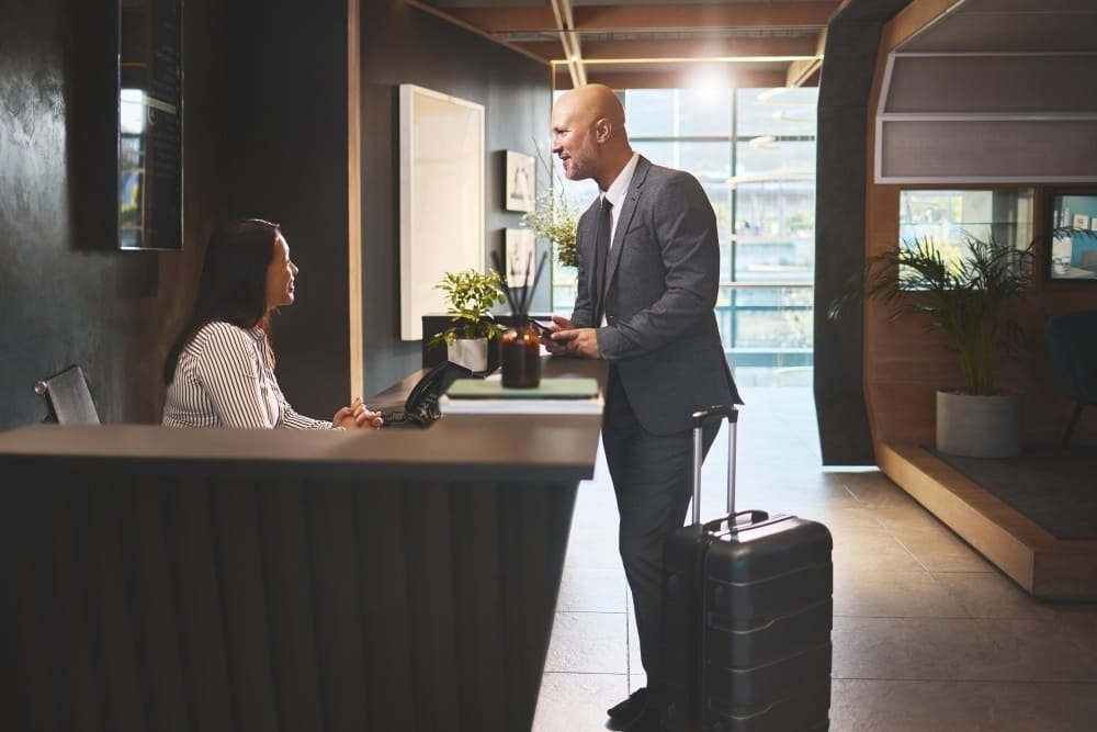 receptionist at counter in hotel young