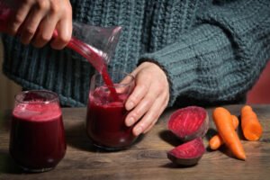 Midsection of man holding red juice