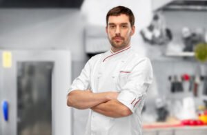 Happy smiling male chef with crossed arms