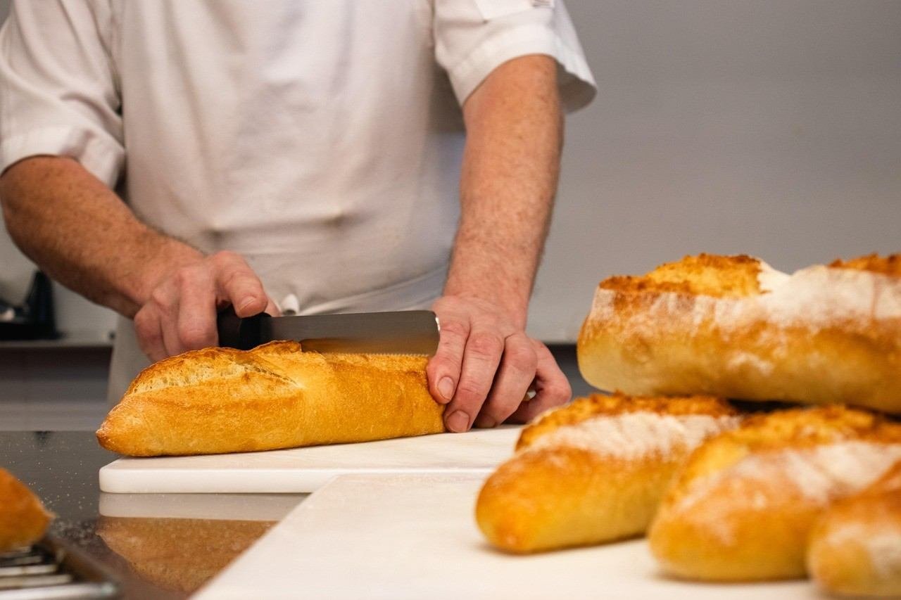 degree in hotel management - a student joined course and learning about how to cut bread