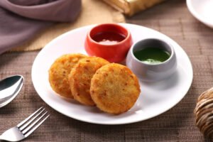 Indian food aloo ki tikki potato patties served with chutneys