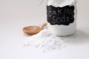 Close-up of baking soda in jar with wooden
