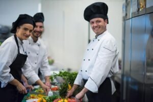 Professional team cooks and chefs preparing