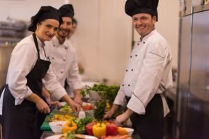Professional team cooks and chefs preparing meal