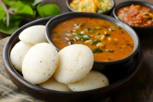 Traditional idli sambar with colorful chutneys south indian