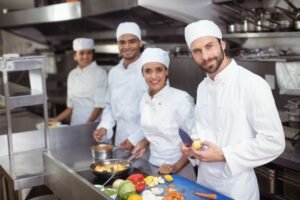 Professional team cooks and chefs preparing meals 