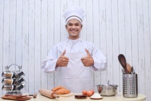 Happy smiling male chef in toque showing