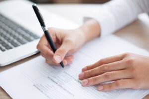 Closeup of business person completing form