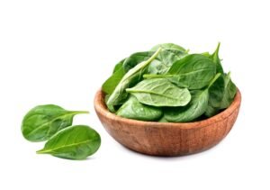 fresh organic spinach salad wooden plate