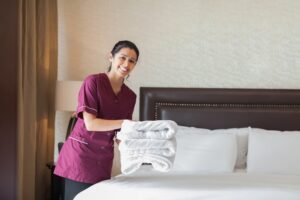 happy maid working hotel room