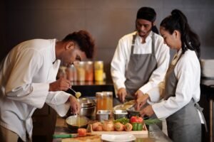 cooks working in kitchen of fancy restaraunt